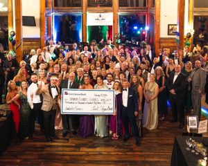 a large group holding an oversized check
